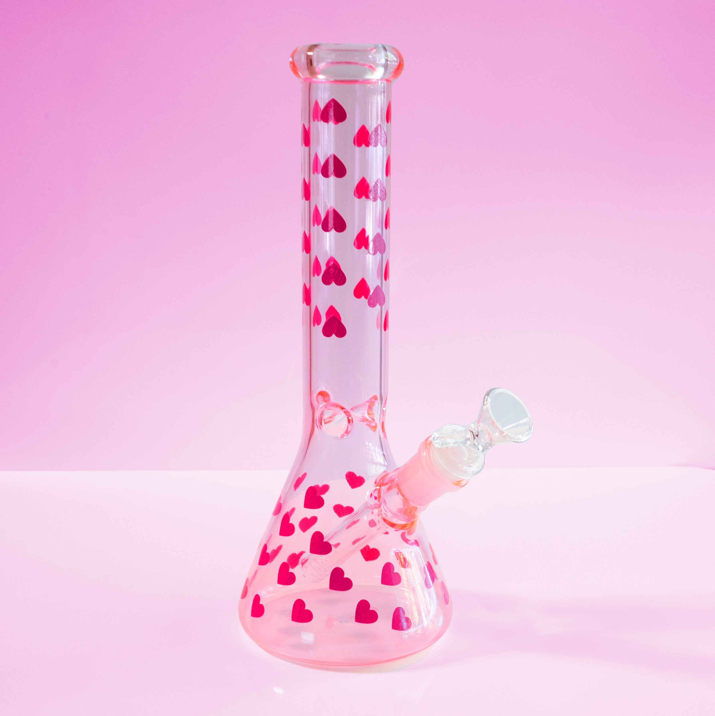 Love Her Madly cute pink hearts bong by Cannabitches, pink beaker on pink backdrop