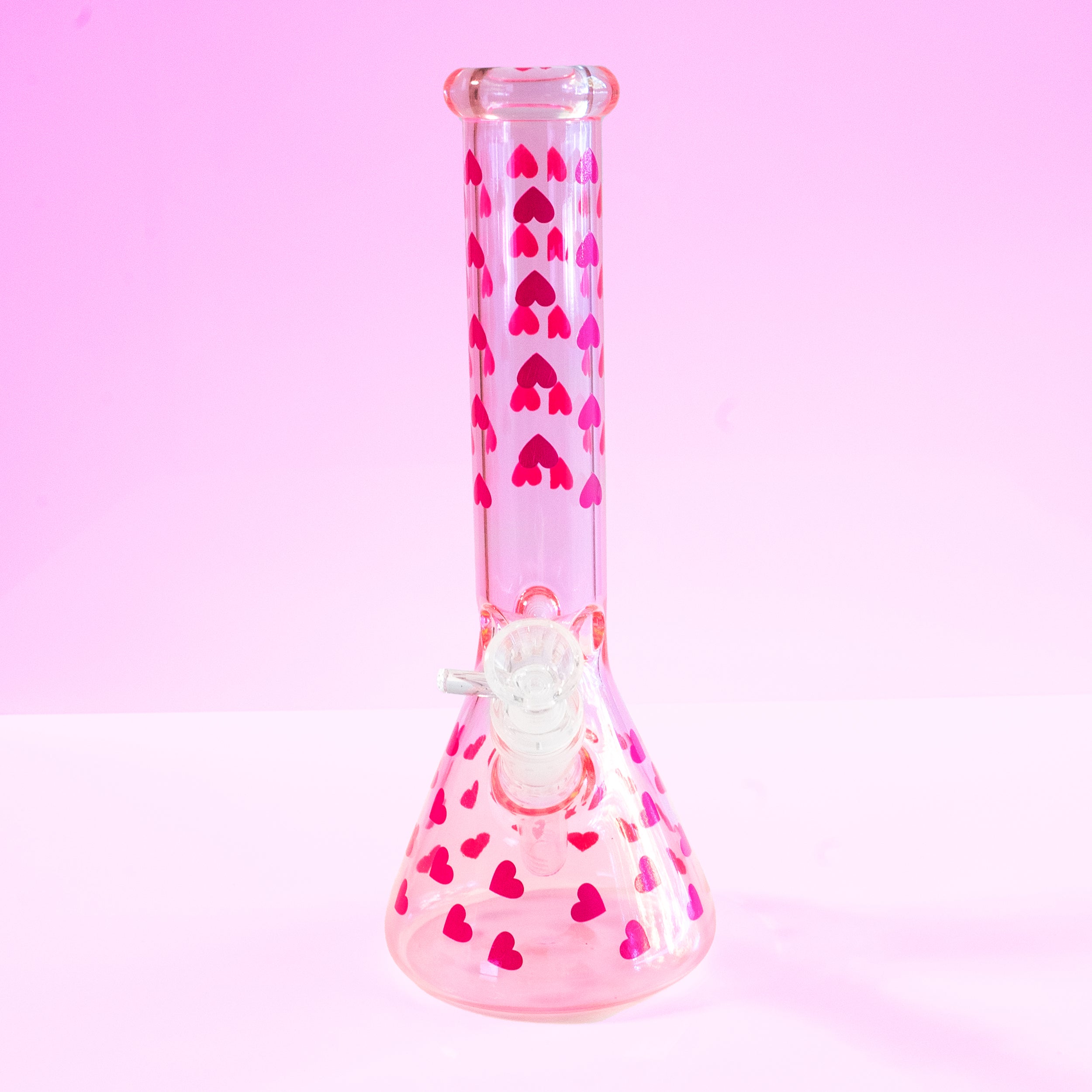 Love Her Madly pink hearts beaker bong by Cannabitches, glass bong with heart pattern, side view