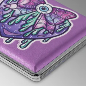 Purple Eye Love You to Death stash case by Tarryn Ann, close-up of the purple winged eye