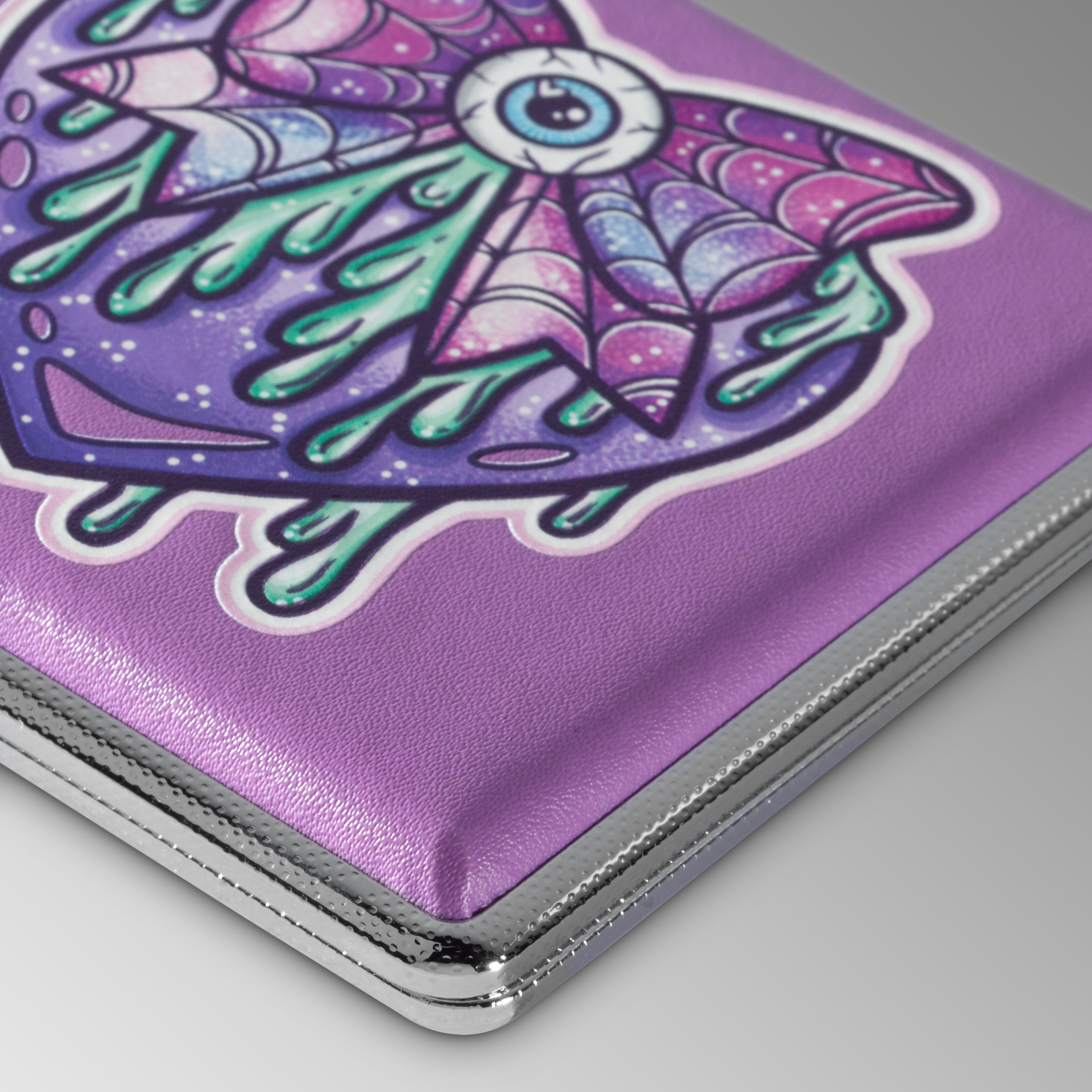 Purple Eye Love You to Death stash case by Tarryn Ann, close-up of the purple winged eye