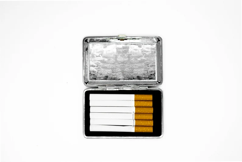 The Fool tarot card stash case by Cannabitches, open silver case holding cigarettes