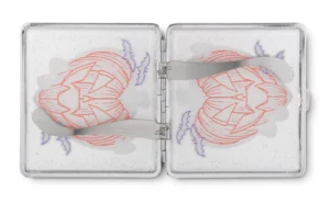 Pumpkin King stash case by Tarryn Ann, open metal case holding pre-rolled joints