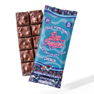 Day Tripper mushroom chocolate bar in crunch flavor, milk chocolate beside wrapper